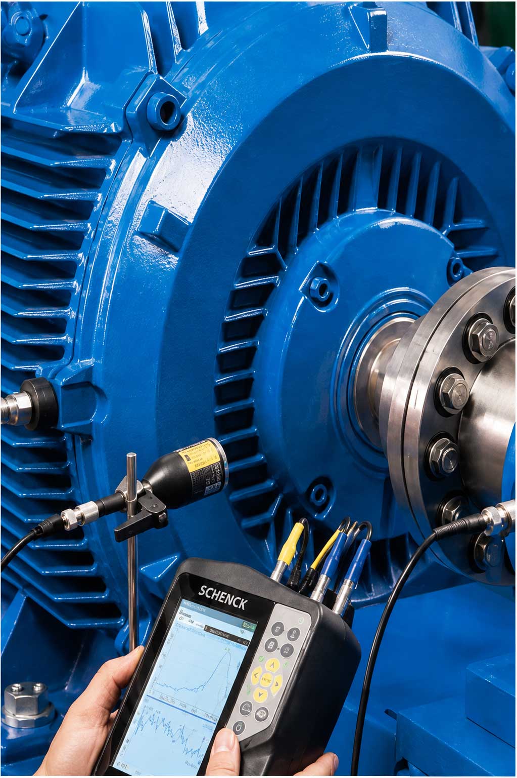 Technician taking vibration readings on an industrial motor
